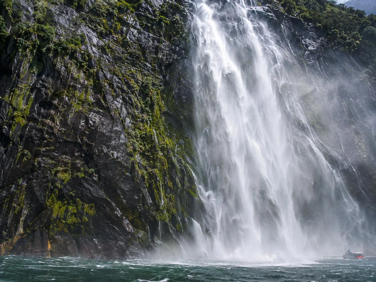 Stirling Falls dropping 151 metres beside a cruise boat